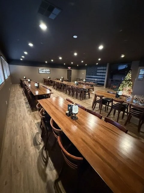 The banquet room with rows of wooden tables, ready for a large group