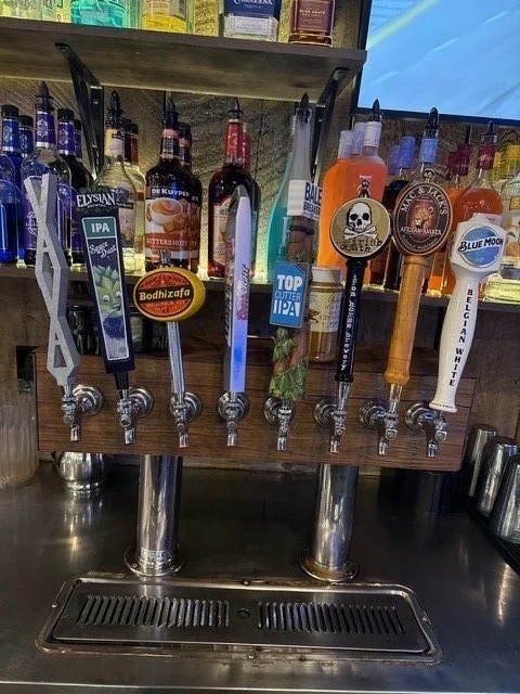A row of beer tap handles on the bar
